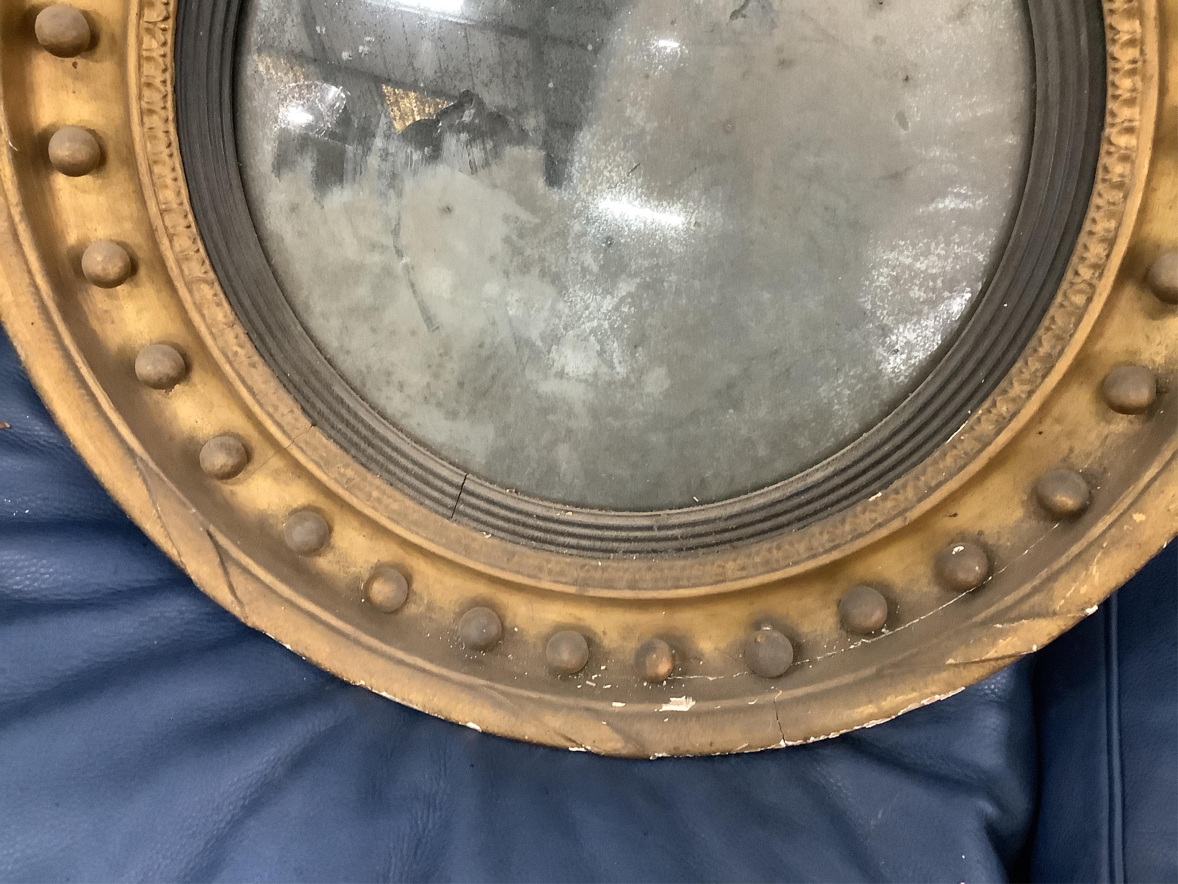 A Regency circular giltwood convex wall mirror with lion pediment, diameter 65cm a Regency convex mirror frame and Victorian girandole. Condition - poor